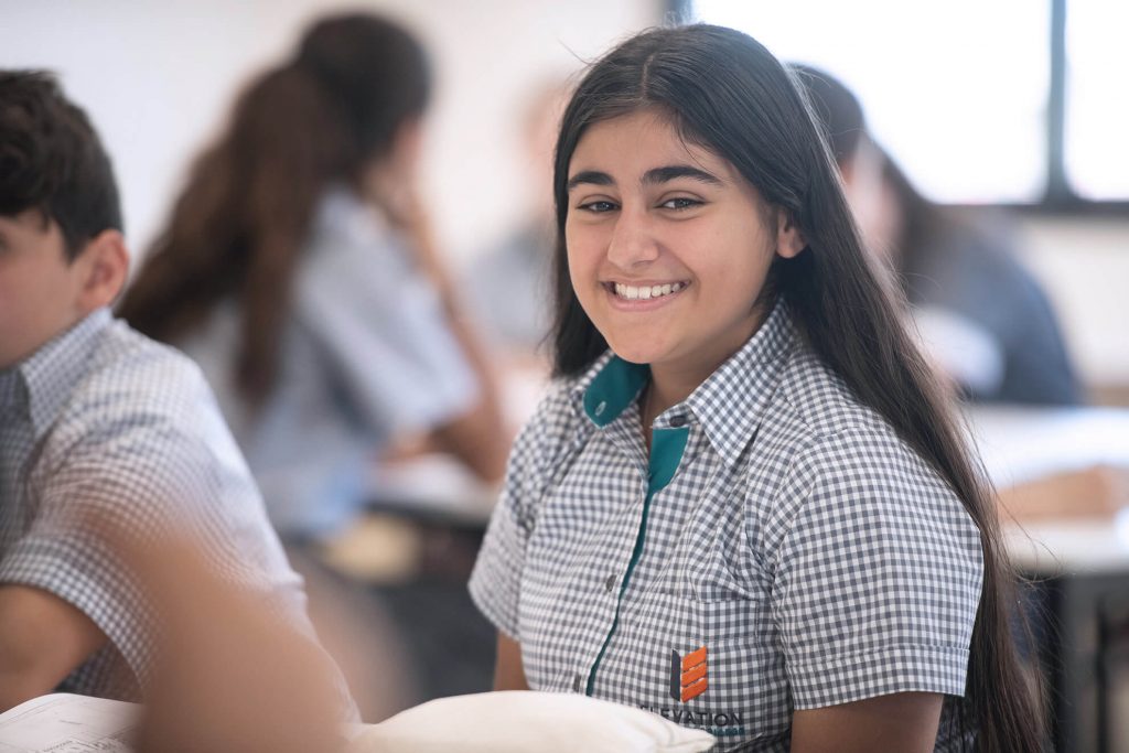 Student in uniform smiling